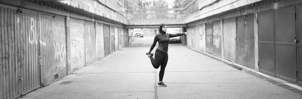 Woman stretching her legs before running