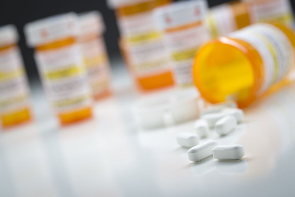 Medicine Bottles Behind Pills Spilling From Fallen Bottle