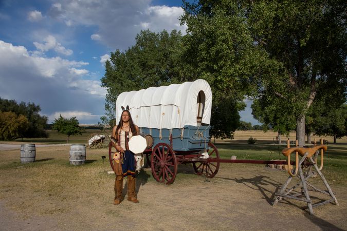 Native American man with covered stage coach at Fort Laramie National Historic Site in Goshen County