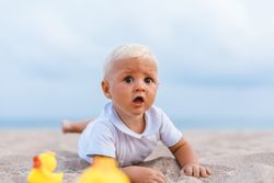 Baby boy playing with rubber ducks