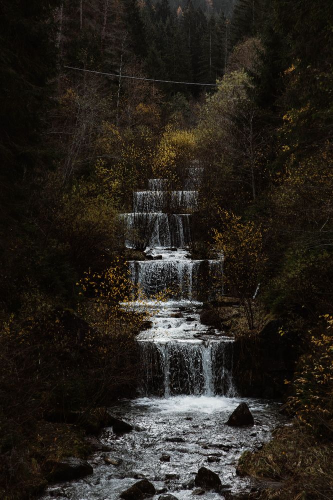 Cascade mountain river at autumn forest