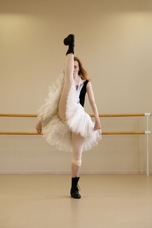 Ballerina in shoes and tutu, high leg extension