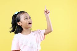 Asian Girl AHA Great Idea Concept on Yellow Background