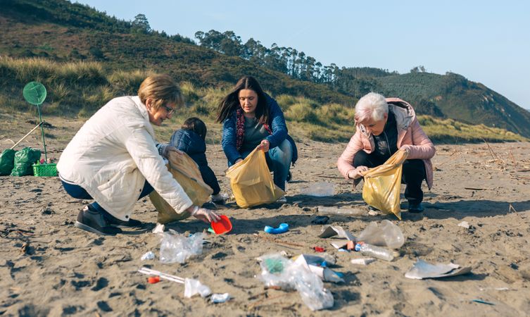 Female volunteers cleaning the beach