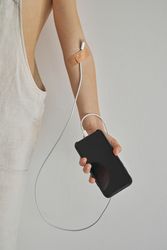 Crop child with charging cable attached to arm