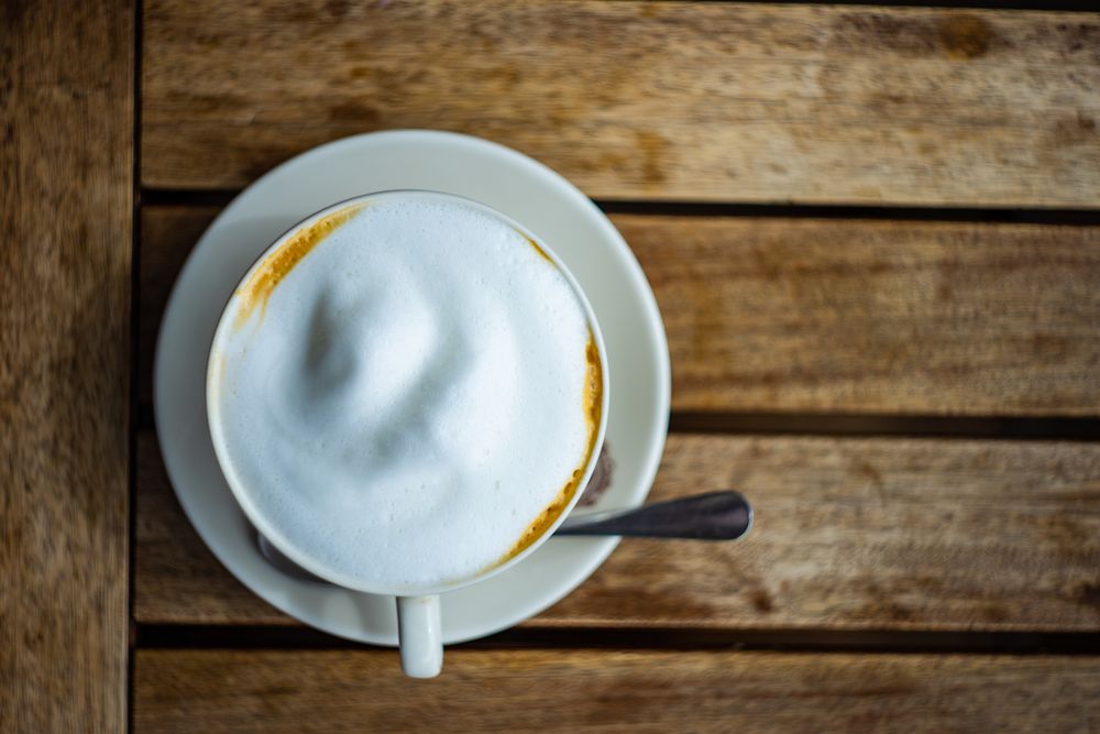 Top view of cup of frothy morning cappuccino