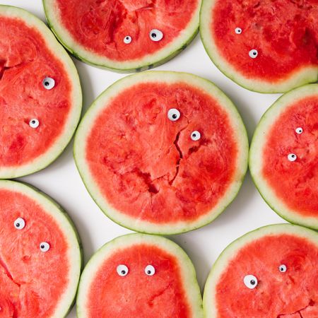 Watermelon slices making faces with googly eyes