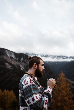 Man delighting in views of forest and mountains