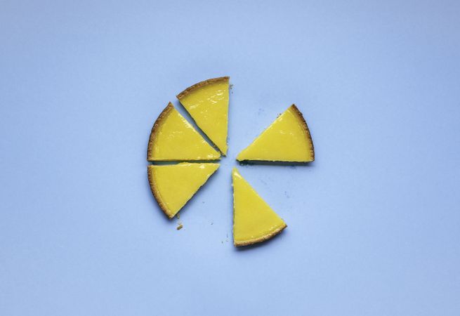 Slices of lemon pie on blue background