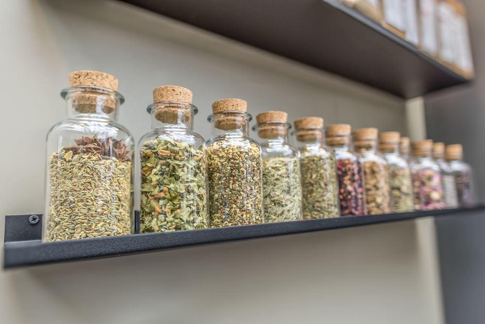 Bottles with tea ingredients on shelf