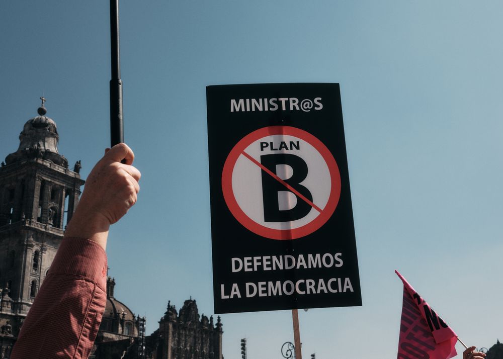 Mexico City, Mexico - February 26th, 2022: Sign being held up against blue sky at protest in Zocalo