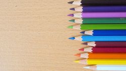 Color pencils in wood texture background