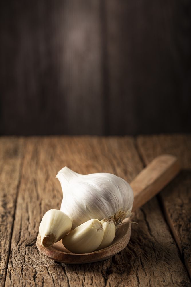 Garlic bulb and garlic cloves on the wooden table.