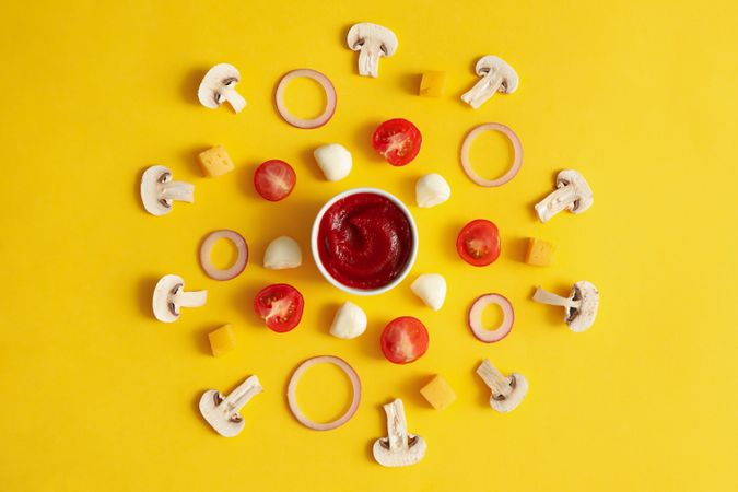 Ingredients for cooking pizza on yellow background