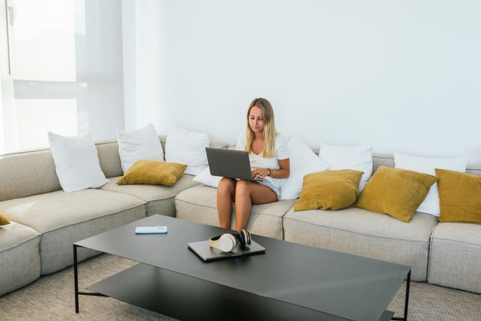 Woman browsing laptop on couch