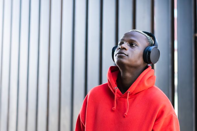 Content Black young man listening to music in headphones
