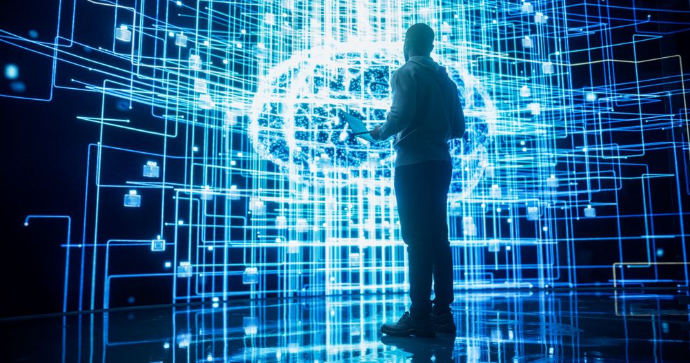 Back View of Young Man Looking at a Big Screen with Neural Network 3D Visualisation.