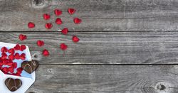 Valentine with cookies and love letter on aged wood
