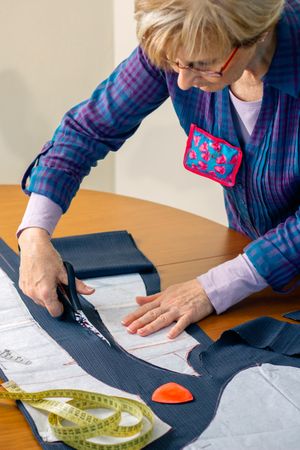 Dressmaker cutting a cloth