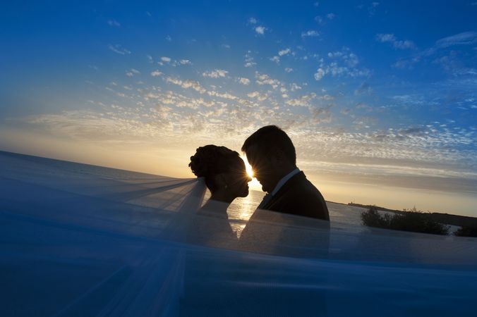 Marriage of woman and man embracing in darkness