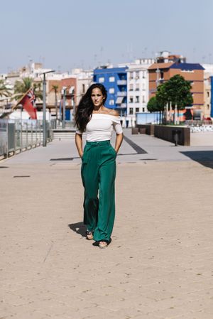 Stylish woman walking on street hands on pocket