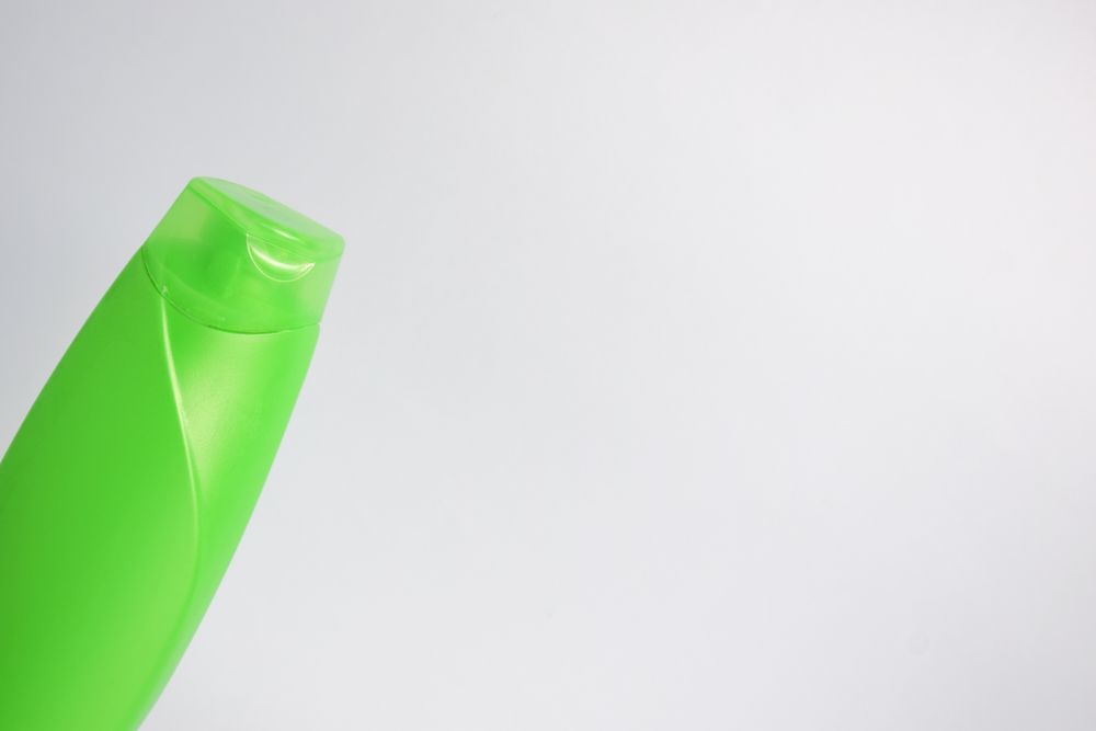 Green shampoo bottle with no labels