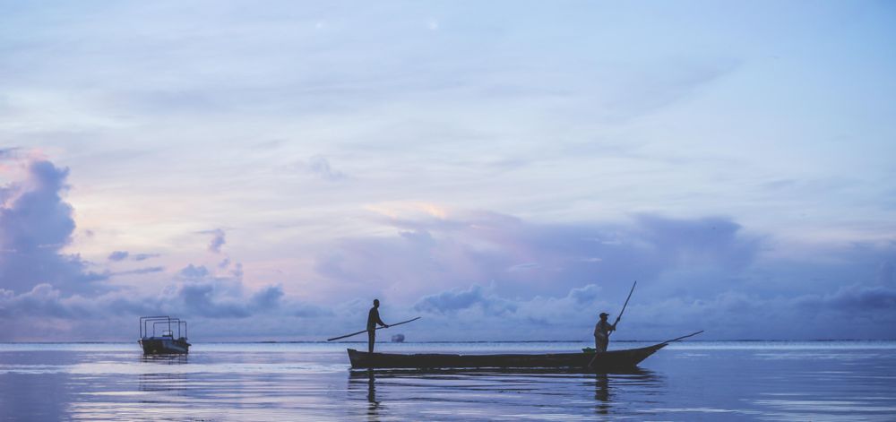 Silhouette two men on boat