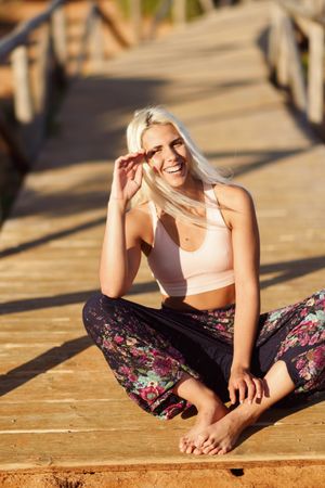 Woman relaxing on wooden bridge