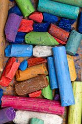 Looking down at dry pastel crayons in the box