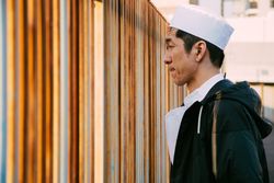 Man wearing Japanese chef hat outdoor in the city