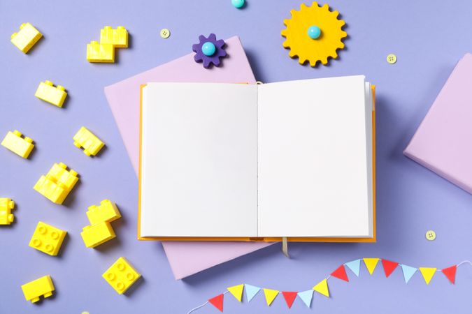 Children's book, with toys, on a purple background.