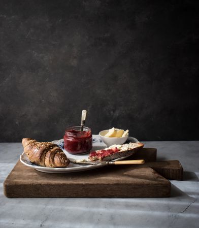 Served breakfast meal with sandwich and jam