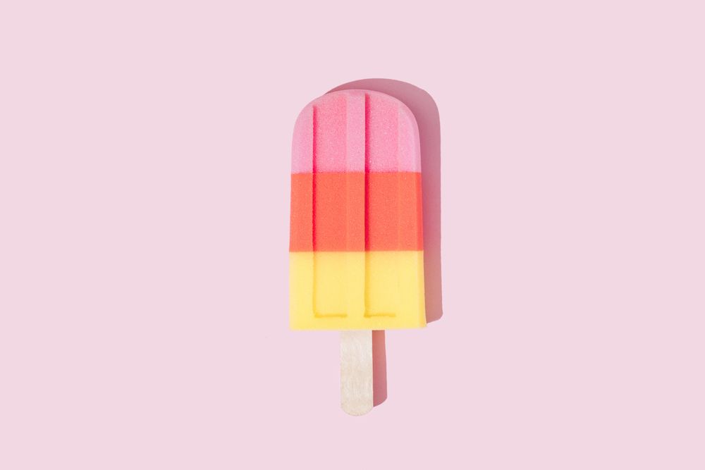 Colorful ice cream popsicle on pastel pink background