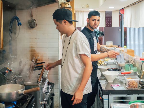 Multiethnic cooks working in kitchen of cafe