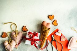 Heart ornaments and gift on grey background