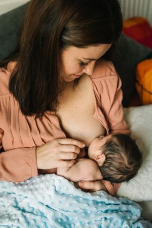 Mom breastfeeding at home