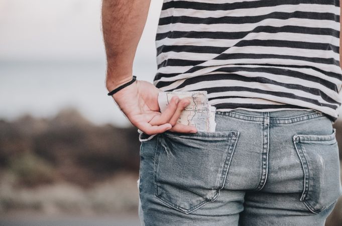 Man standing with map in back pocket