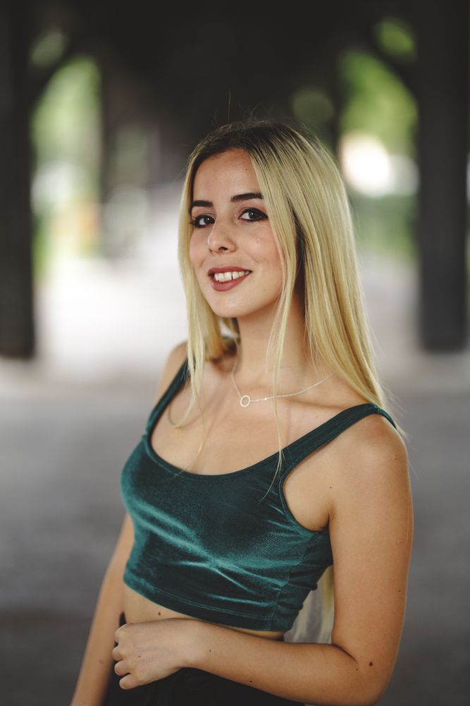 Blonde cheerful model standing and looking at camera