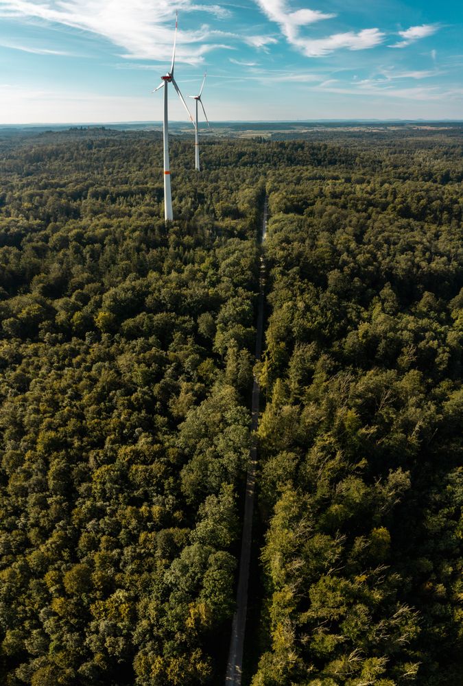 Drone vertical panorama with vast forest and wind turbines, in Baden Wurttemberg region, Germany