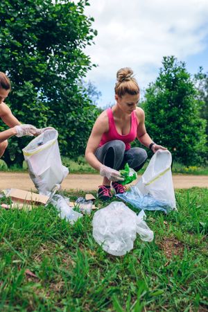 Woman with garbage bag doing plogging