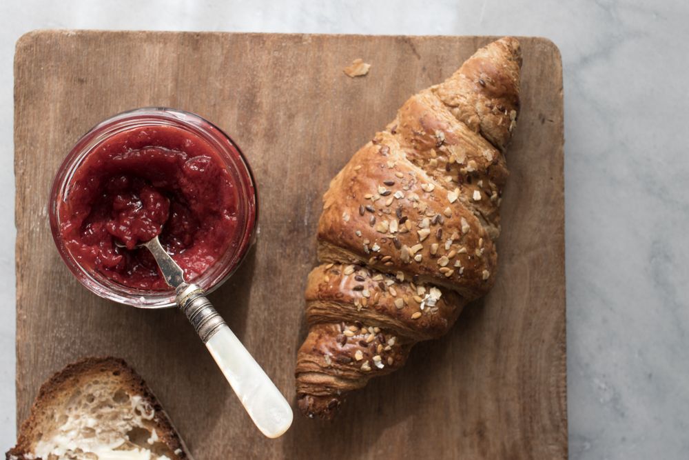 Served breakfast meal with croissant and jam
