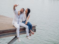 Woman with man taking photo selfie