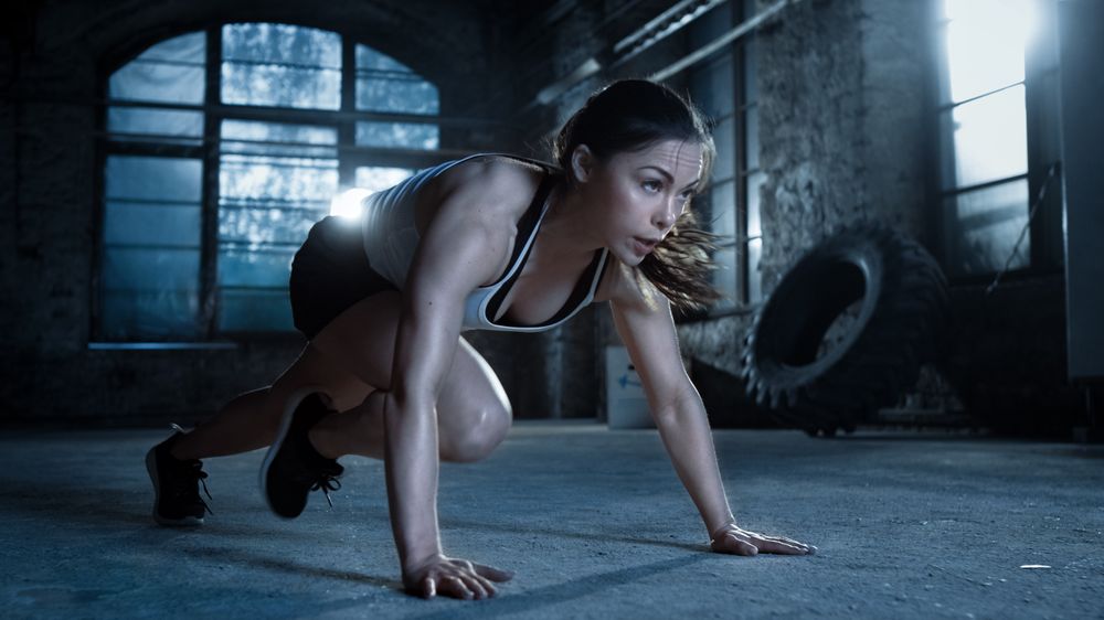 Athletic Woman Does Running Plank as Part of Her Cross Fitness
