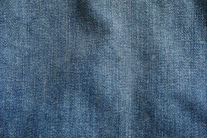 Texture of blue jeans as background, space for text