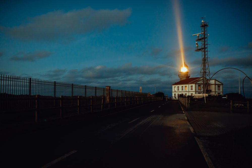 Road and lighthouse in evening