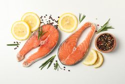 Composition with salmon meat and spices on light background, top view