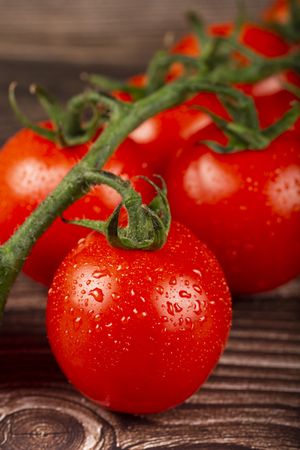 Ripe tomatoes on the wooden table.