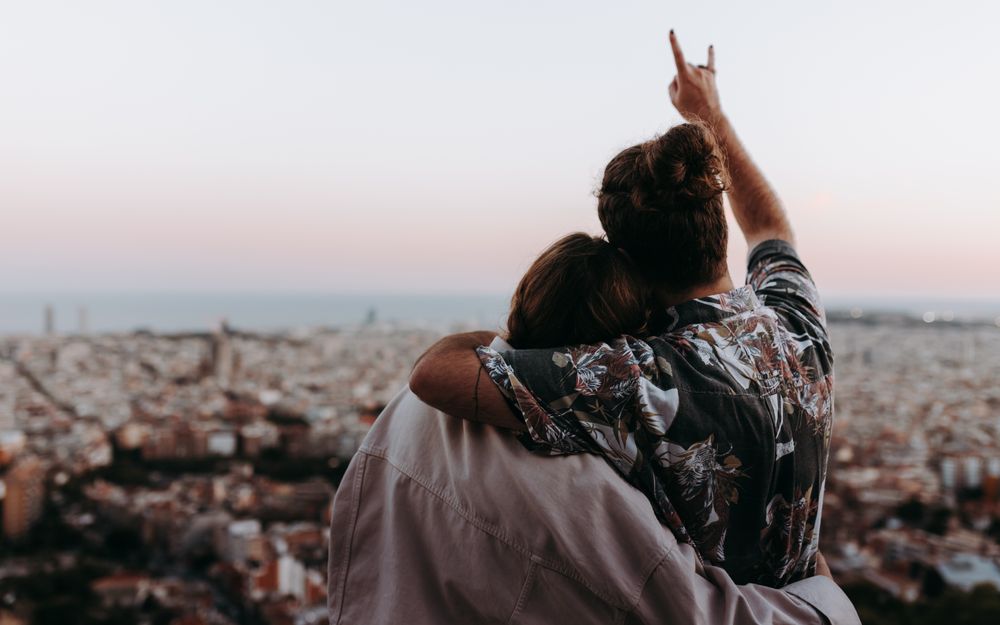Woman and man hugging in front of view