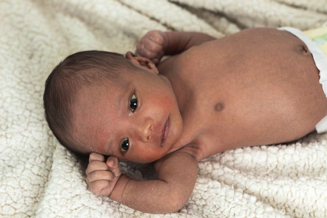 Newborn baby on soft blanket