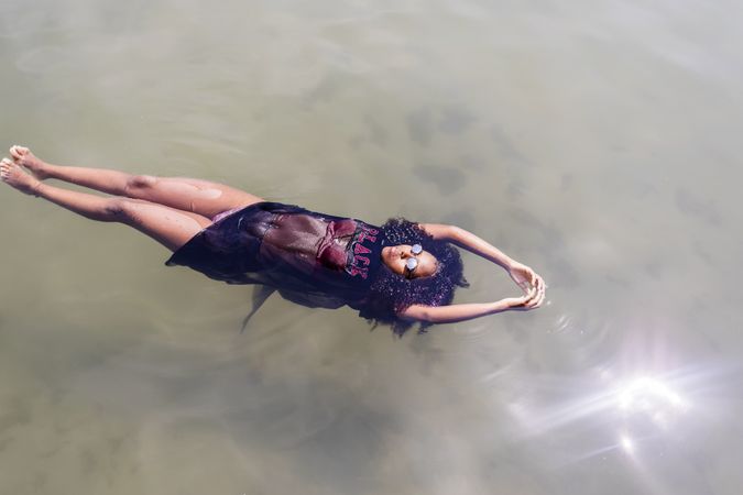 Black woman relaxing in a pool of water